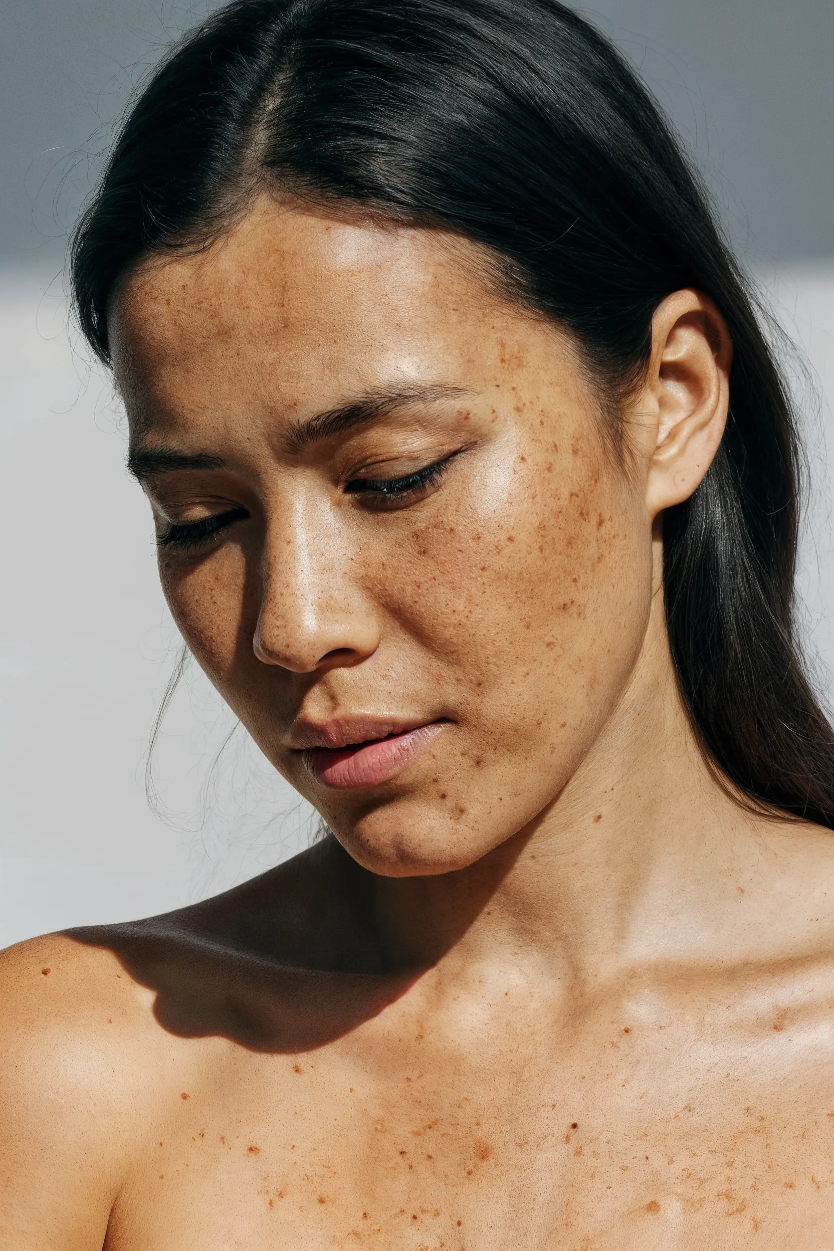 A person with freckled, medium-tan skin